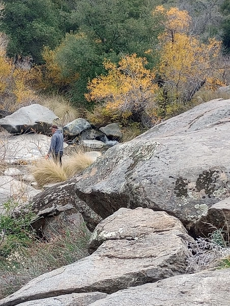 Person traversing rocks in nature